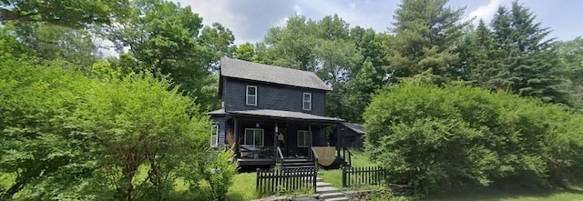 view of front of home with covered porch and fence