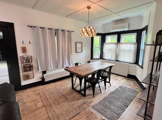 dining room with radiator, radiator heating unit, light wood-style flooring, coffered ceiling, and a wall mounted AC