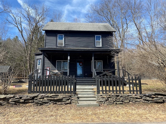 view of front of house with a fenced front yard, a porch, and a gate