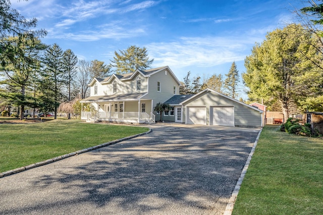 view of front of house with a porch, an attached garage, driveway, and a front lawn