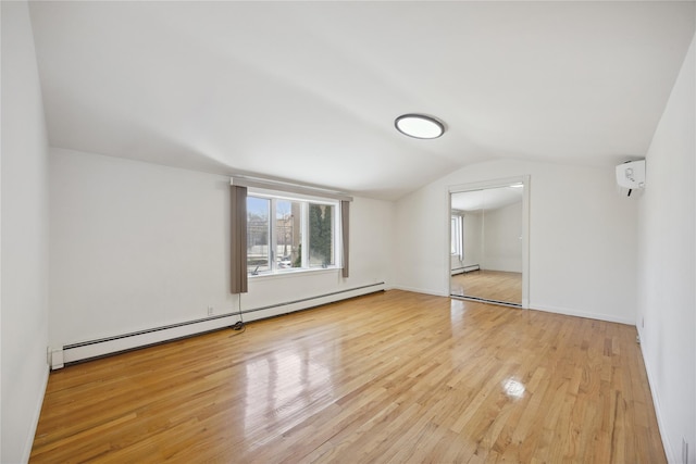additional living space featuring a wall mounted air conditioner, a baseboard heating unit, wood finished floors, and lofted ceiling
