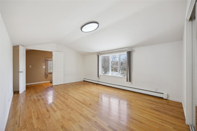 bonus room with baseboard heating, light wood-type flooring, baseboards, and lofted ceiling