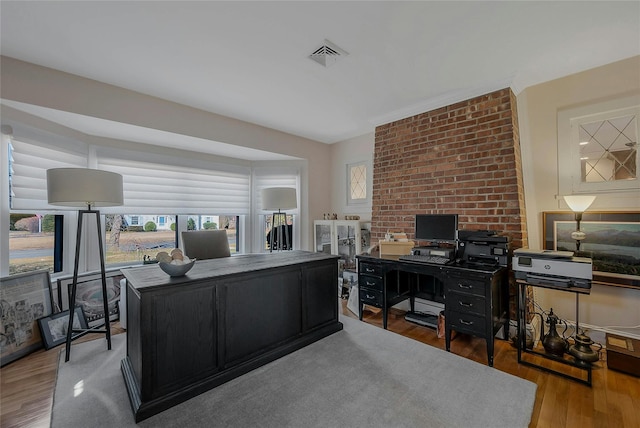 home office with visible vents and wood finished floors