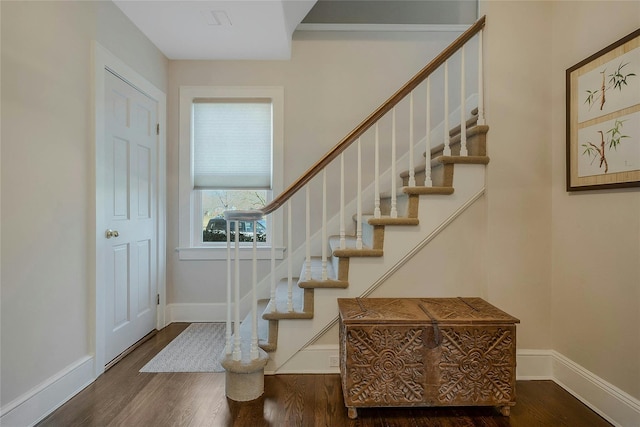 stairs featuring baseboards and wood finished floors