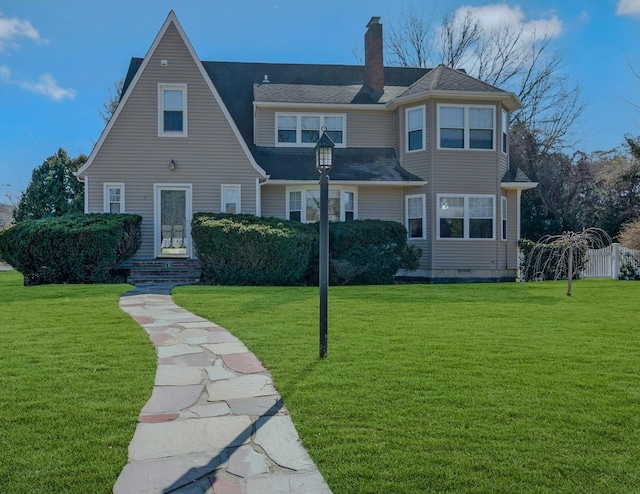 view of front of home featuring a front yard and a chimney