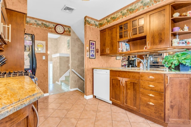 kitchen featuring brown cabinets, visible vents, dishwasher, and open shelves