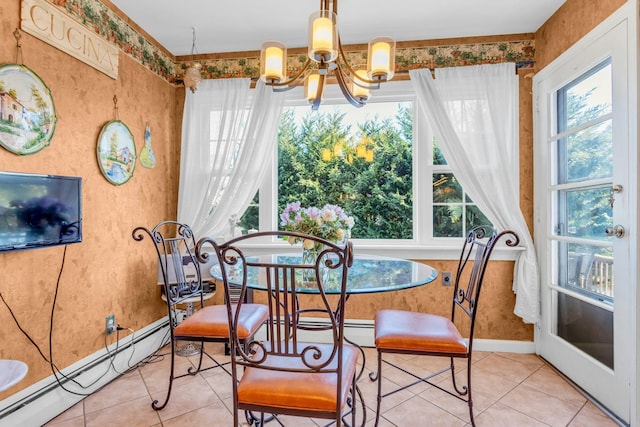 dining space with a healthy amount of sunlight, a baseboard heating unit, a notable chandelier, and tile patterned floors