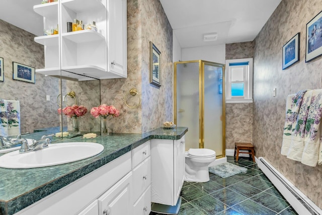 bathroom with toilet, a baseboard heating unit, vanity, a shower stall, and wallpapered walls