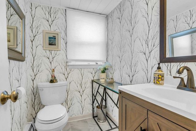 half bath featuring toilet, wallpapered walls, marble finish floor, and vanity