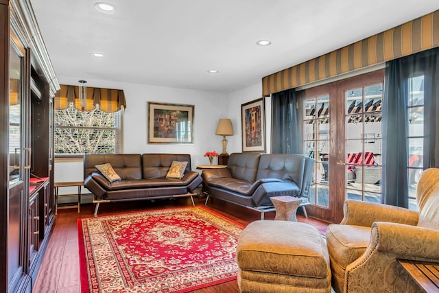 living room featuring recessed lighting, a baseboard heating unit, wood finished floors, and french doors