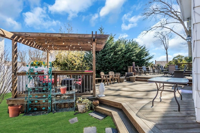 wooden deck featuring a lawn and a pergola