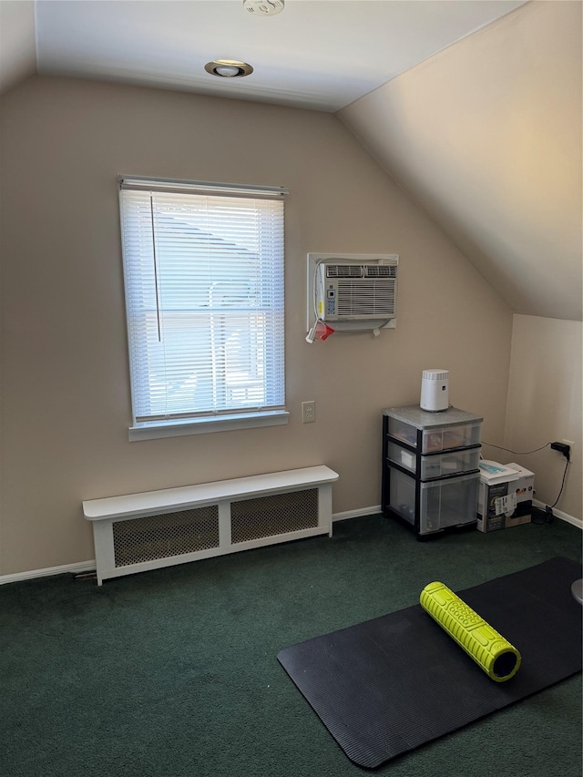 bonus room with radiator, a wall unit AC, vaulted ceiling, and carpet flooring