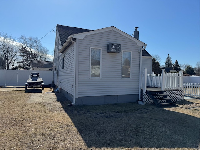 view of home's exterior featuring crawl space, roof with shingles, fence, and a deck