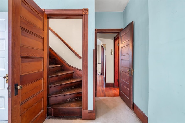 staircase with carpet floors and baseboards