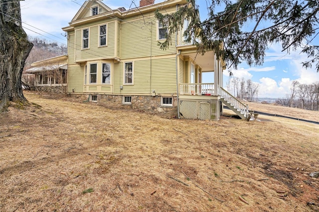 exterior space with a chimney and stairway