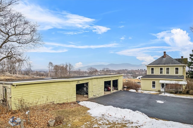 exterior space featuring an outdoor structure and a mountain view