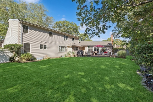 back of house featuring a garage, a yard, and a patio