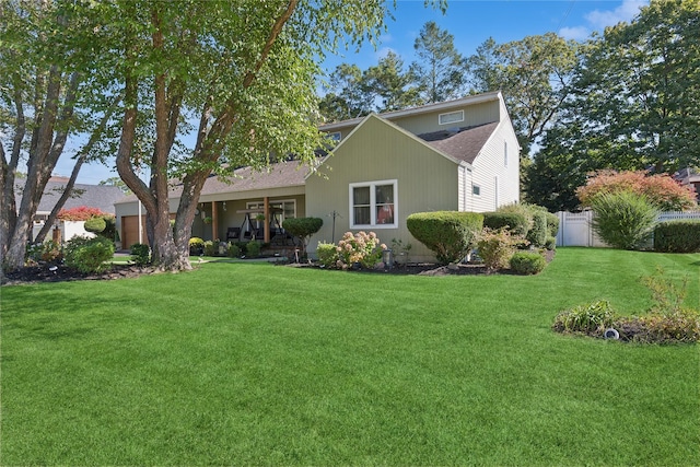 back of house with a lawn and fence