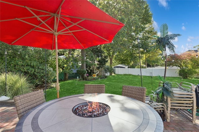 view of patio featuring an outdoor fire pit, outdoor dining area, and fence