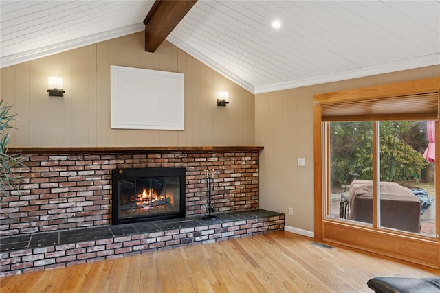 unfurnished living room featuring visible vents, baseboards, wood-type flooring, vaulted ceiling with beams, and a fireplace