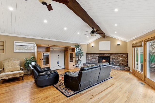 living area with light wood finished floors, visible vents, lofted ceiling with beams, baseboard heating, and a brick fireplace