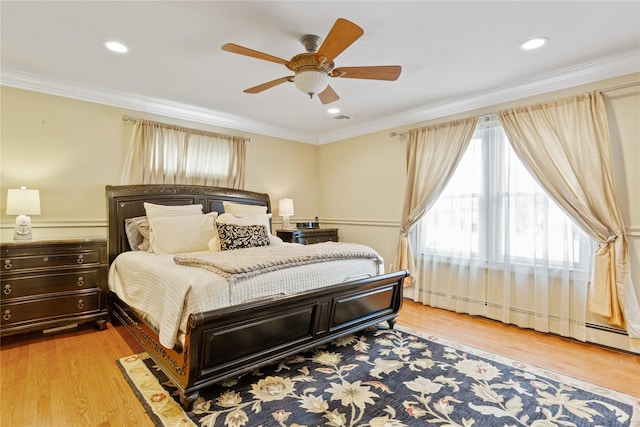 bedroom with light wood finished floors, a baseboard radiator, ornamental molding, and ceiling fan