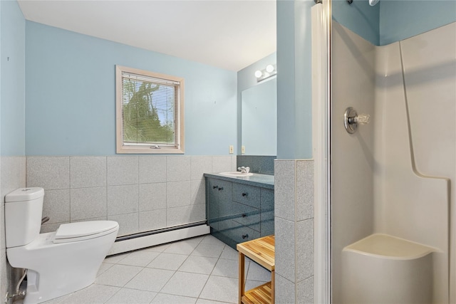 full bathroom with a stall shower, wainscoting, tile patterned floors, a baseboard heating unit, and tile walls