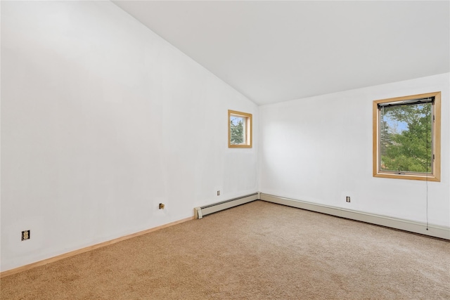 carpeted empty room featuring lofted ceiling, a baseboard radiator, and baseboards