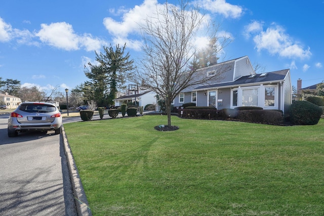 dutch colonial featuring a front lawn