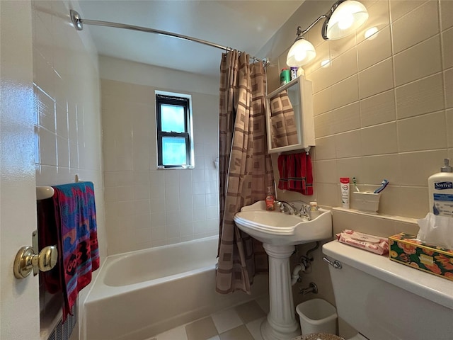 full bathroom featuring toilet, shower / tub combo, and tile walls