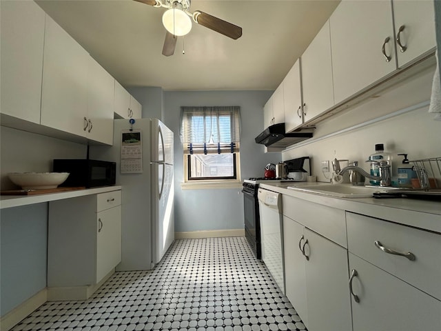 kitchen featuring white cabinets, a sink, white appliances, under cabinet range hood, and baseboards