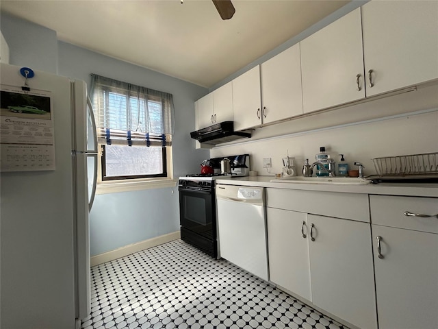 kitchen featuring white appliances, baseboards, light countertops, under cabinet range hood, and a sink