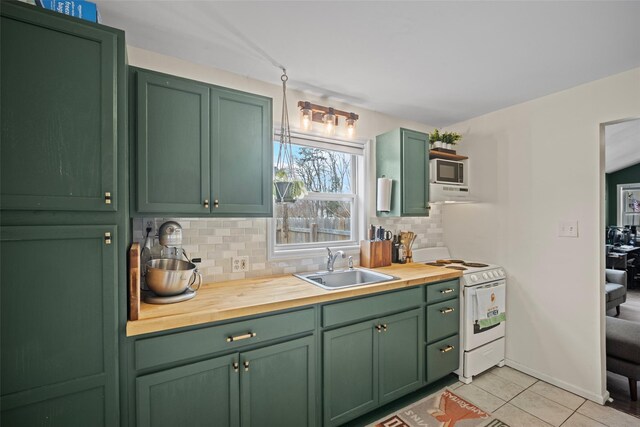 kitchen with white electric range, a sink, wood counters, built in microwave, and green cabinetry