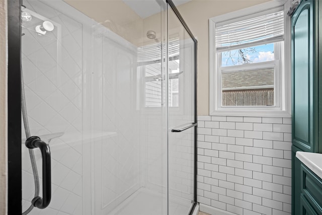 full bath featuring vanity, a shower stall, and tile walls