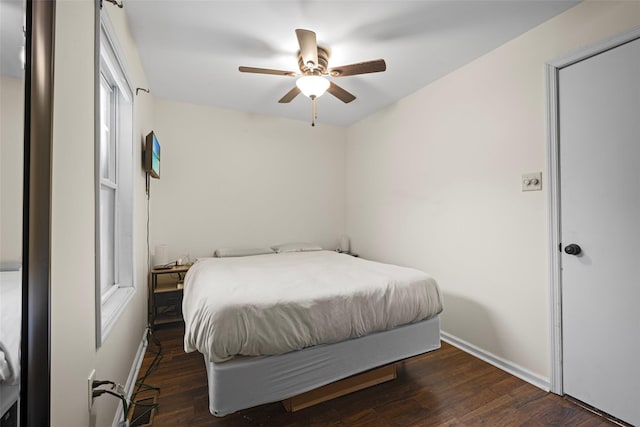 bedroom with ceiling fan, baseboards, and wood finished floors