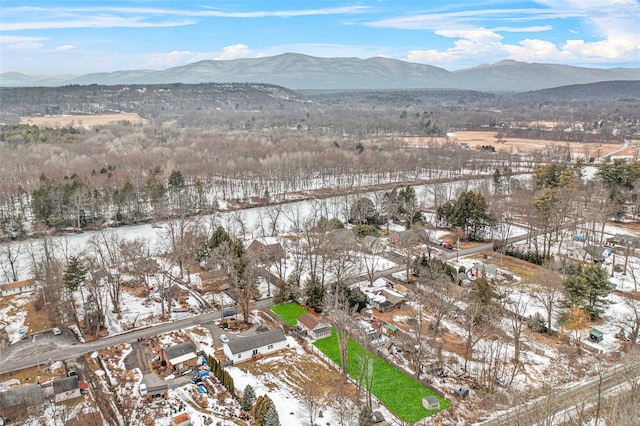 snowy aerial view featuring a mountain view