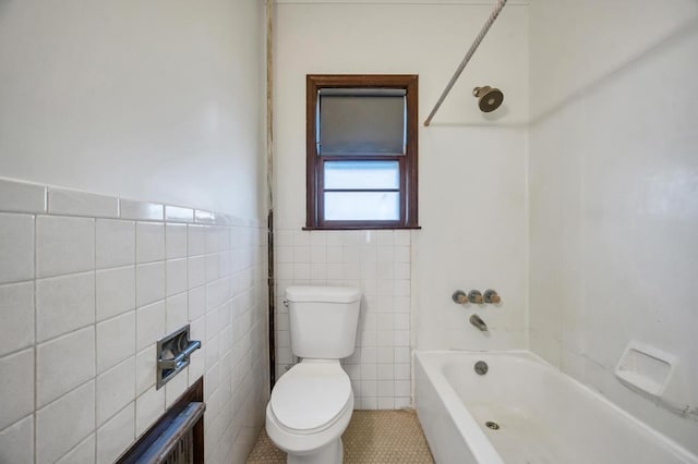 full bath featuring a wainscoted wall, tub / shower combination, tile walls, and toilet