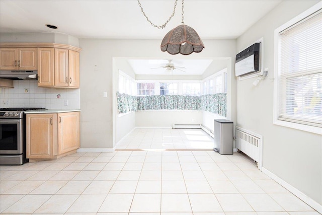 kitchen with a wall unit AC, light brown cabinets, under cabinet range hood, radiator heating unit, and gas stove