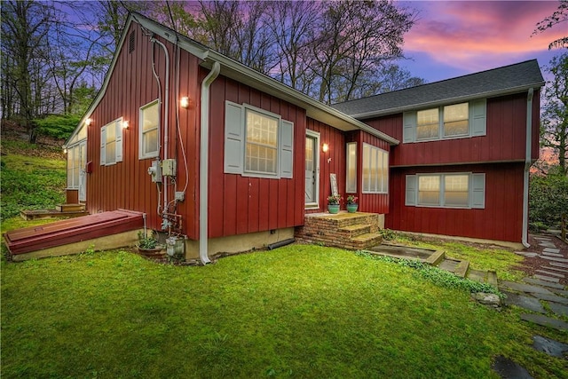 exterior space featuring board and batten siding and a yard