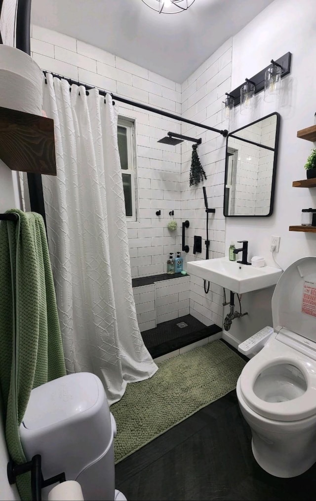 full bath featuring toilet and tiled shower