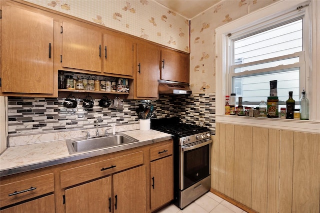 3709 20th Rd, Astoria, NY 11105 - kitchen with gas range, a sink, under cabinet range hood, wallpapered walls, and backsplash