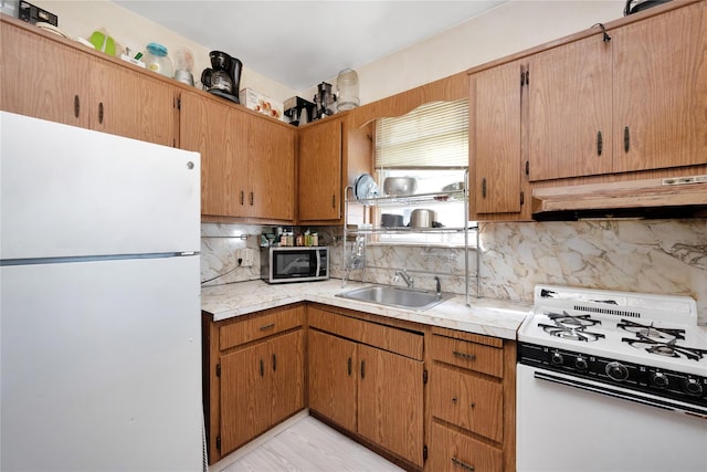3709 20th Rd, Astoria, NY 11105 - kitchen with white appliances, a sink, under cabinet range hood, light countertops, and tasteful backsplash