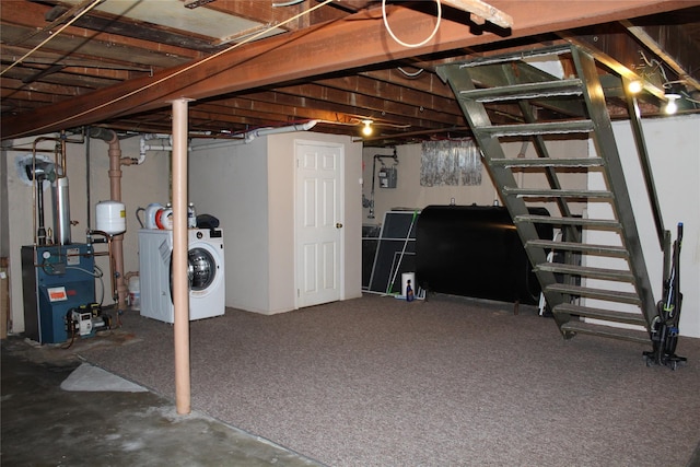 unfinished basement with washer / dryer, a heating unit, and heating fuel