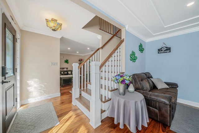 interior space featuring ornamental molding, wood finished floors, and baseboards