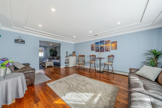 living room with ornamental molding, visible vents, and wood finished floors