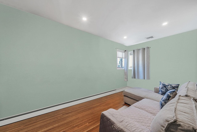 living area with a baseboard radiator, visible vents, recessed lighting, and wood finished floors