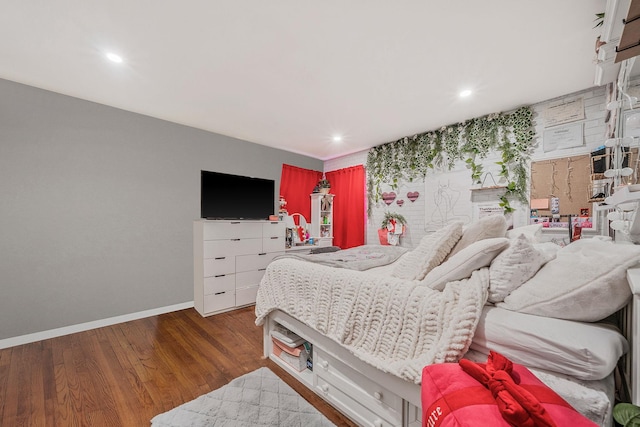 bedroom featuring baseboards, wood finished floors, and recessed lighting