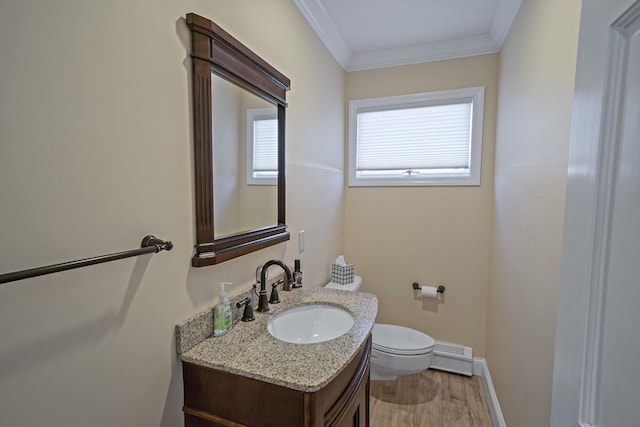 half bathroom featuring baseboards, toilet, crown molding, vanity, and a baseboard heating unit