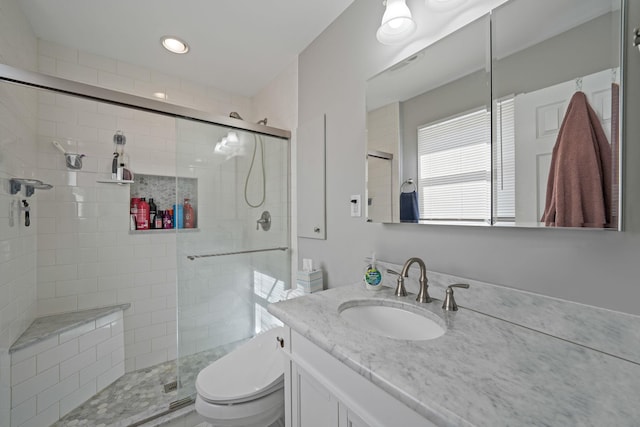 full bathroom with toilet, a shower stall, recessed lighting, and vanity