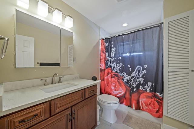 bathroom featuring curtained shower, vanity, and toilet